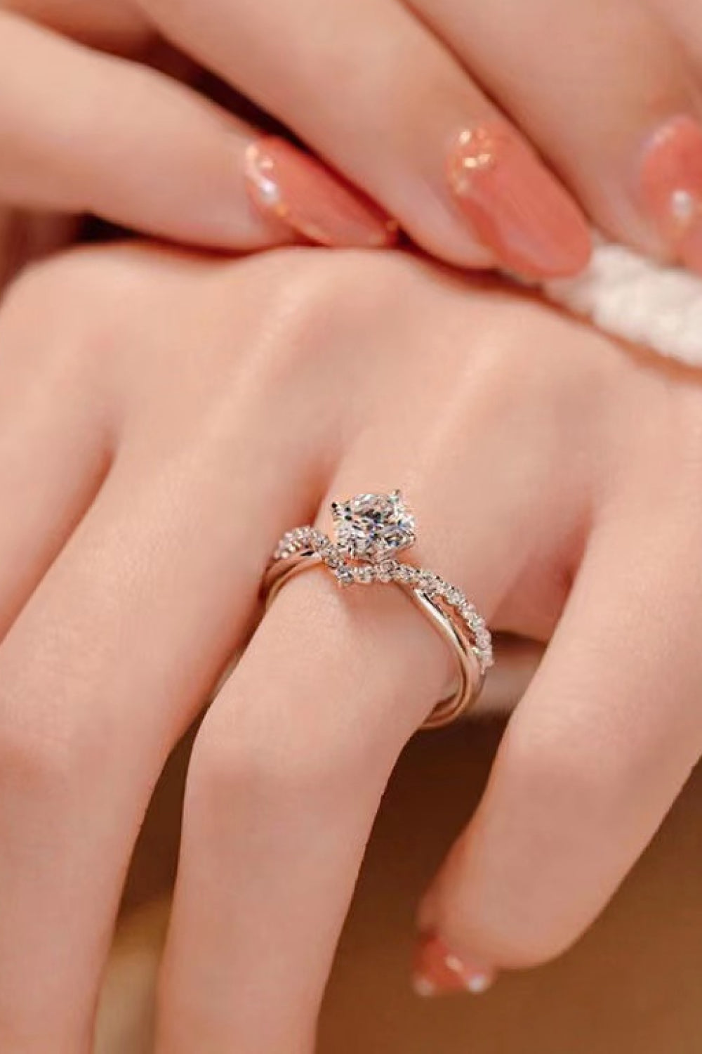 Bold Beauty 1 Carat Moissanite Heart-Shaped Ring on lovely hand with peach nails